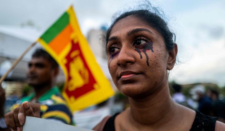 A protester at an anti-government demonstration near the president's office in Colombo | AFP