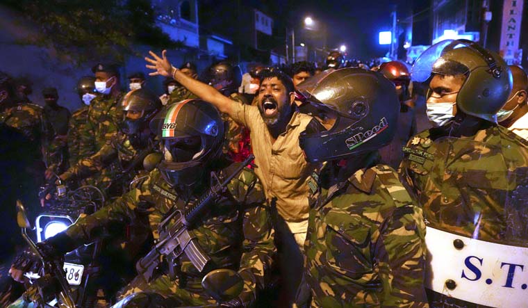 A Sri Lankan man shouts anti-government slogans during a protest in Colombo | AP