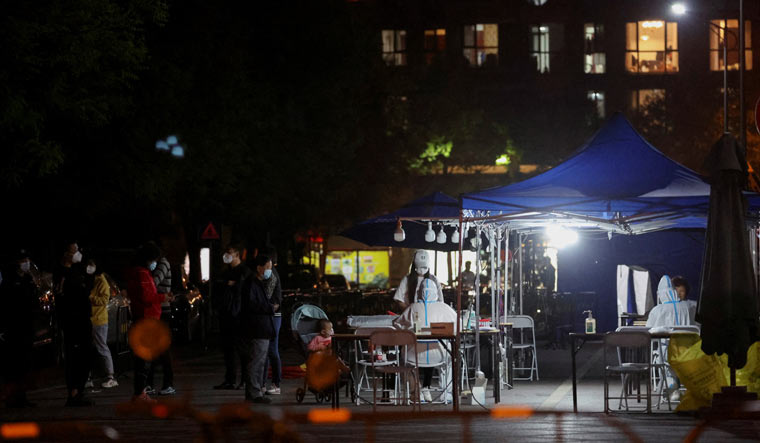 Residents line up at a makeshift Covid testing site in Beijing | Reuters
