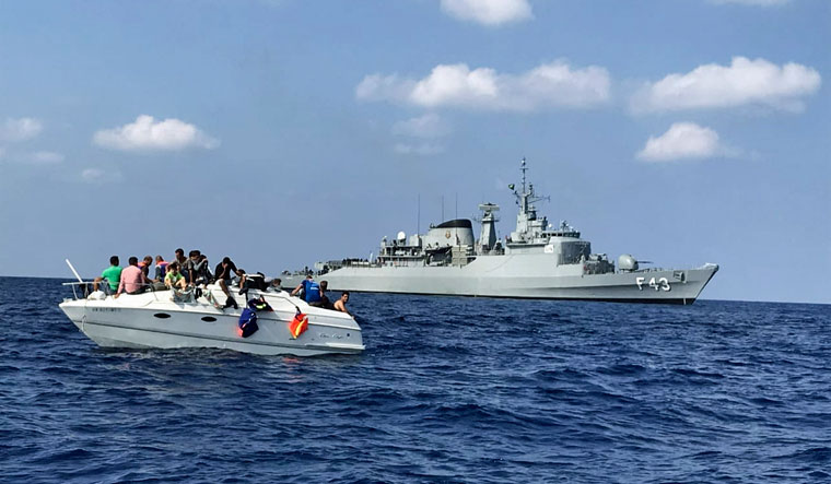 File: United Nations Interim Force in Lebanon's (UNIFIL) flagship, BRS Liberal, approaches a boat overcrowded with migrants in the Mediterranean Sea on Oct. 12, 2018 | AP