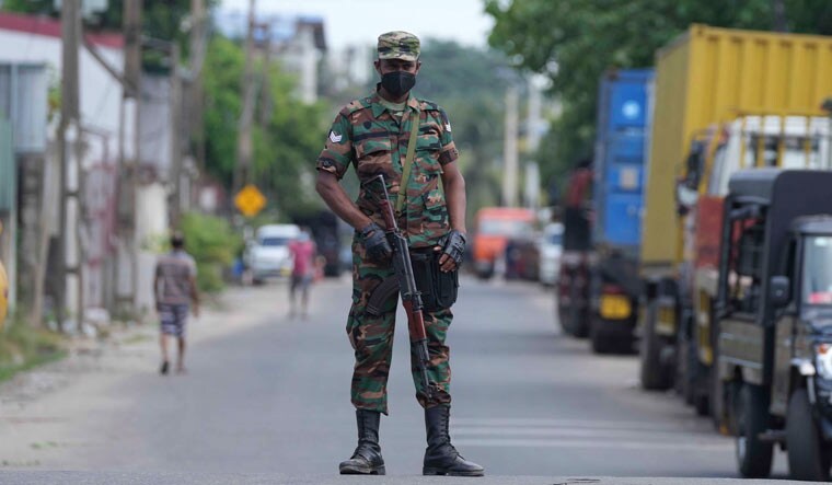 A soldier patrols a road in Colombo during curfew | AP