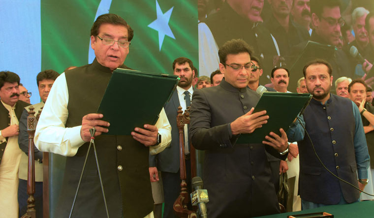 Raja Pervez Ashraf (L) administering the oath to Hamza Shehbaz Sharif (C) | AFP