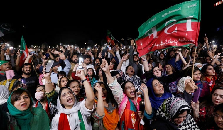Supporters of the Pakistan Tehreek-e-Insaf (PTI) light up their mobile phones and chant slogans in support of  Prime Minister Imran Khan during a rally in Islamabad | Reuters
