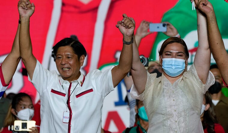 Presidential candidate, Ferdinand Marcos Jr., the son of the late dictator raises arms with running mate Davao City Mayor Sara Duterte, the daughter of the current President, during their last campaign rally Saturday, May 7, 2022 | AP