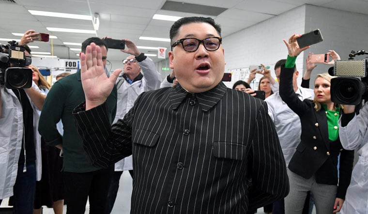 A man impersonating North Korea's leader Kim Jong-un arrives as Prime Minister Scott Morrison leaves Extel Technologies manufacturing facility on Day 33 of the 2022 federal election campaign, in Melbourne, Australia, Friday, May 13, 2022