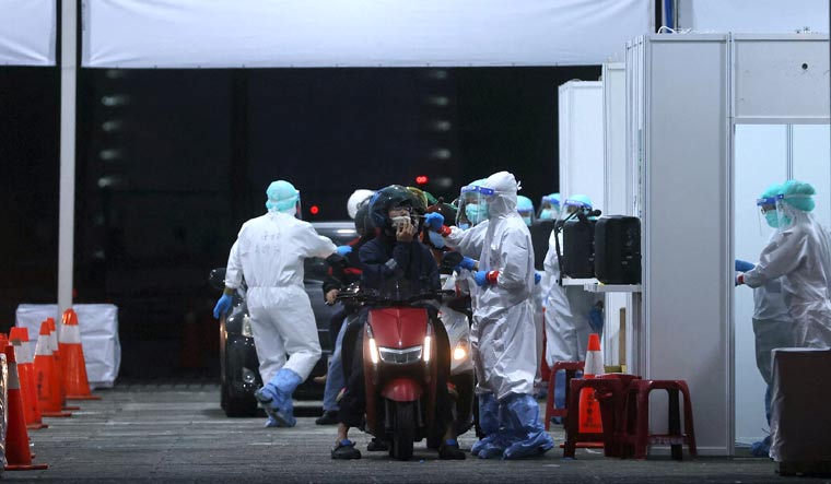 People line up to get a Covid-19 test at a newly set up drive-through site at Liberty Square in Taipei, Taiwan | Reuters