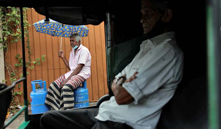 A man waits in line to buy domestic gas tanks near a distributor, amid the country's economic crisis, in Colombo, Sri Lanka, May 23, 2022 | Reuters
