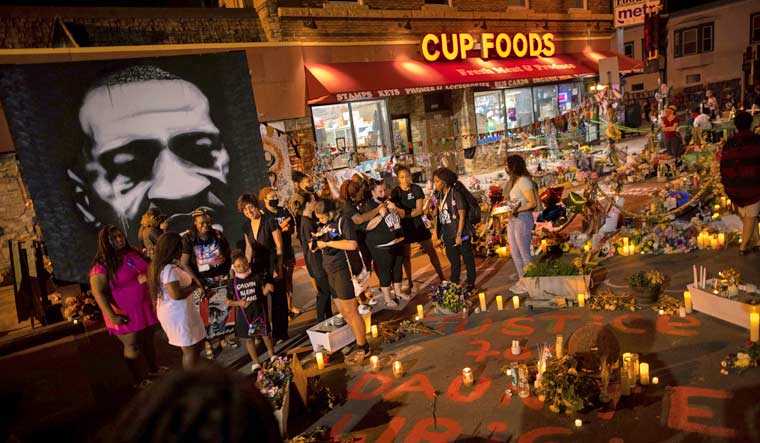 File: People gather on the one-year anniversary of George Floyd's death, May 25, 2021, in Minneapolis | AP