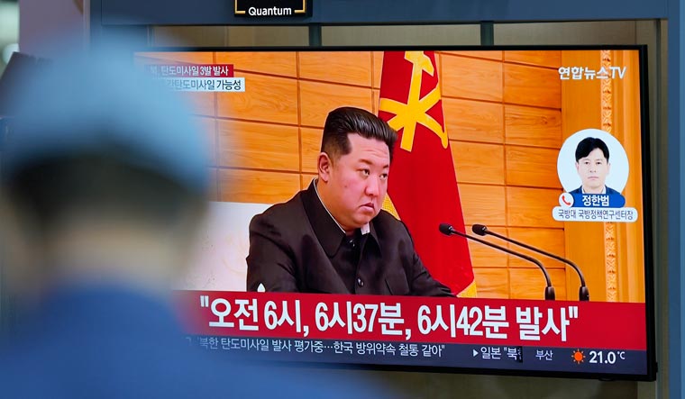A TV screen shows a news program reporting about North Korea's missile launch with a file footage of North Korean leader Kim Jong Un, at a train station in Seoul, South Korea, Wednesday, May 25, 2022