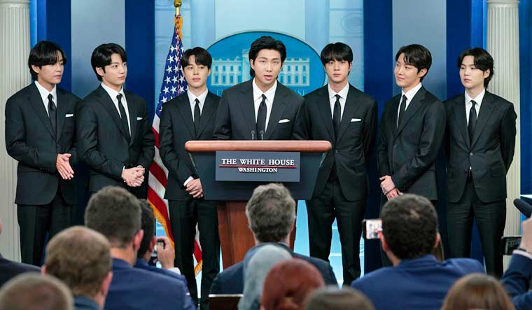 RM, center, accompanied by other K-pop supergroup BTS members from left, V, Jungkook, Jimin, Jin, J-Hope, and Suga speaks during the daily briefing at the White House in Washington, Tuesday, May 31, 2022 | AP