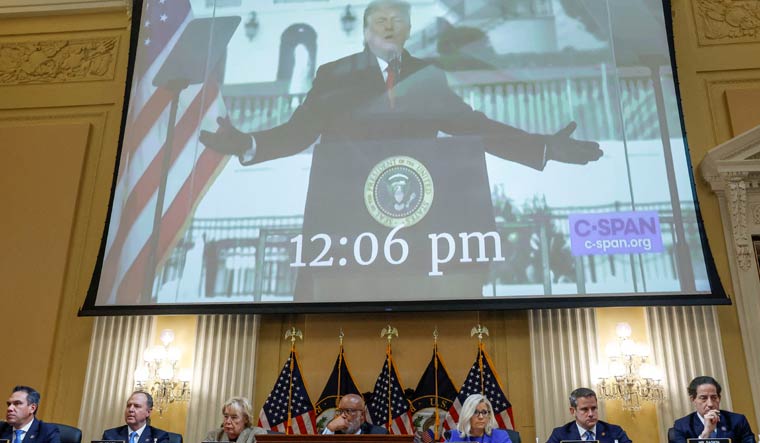A screen showing video of Donald Trump above the January 6 Committee members | Reuters