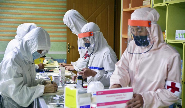 Members of the North Korean army supply medicines to residents at a pharmacy, amid growing fears over the spread of the coronavirus disease (COVID-19), in Pyongyang, North Korea, in this photo released by Kyodo on May 18, 2022 | Reuters