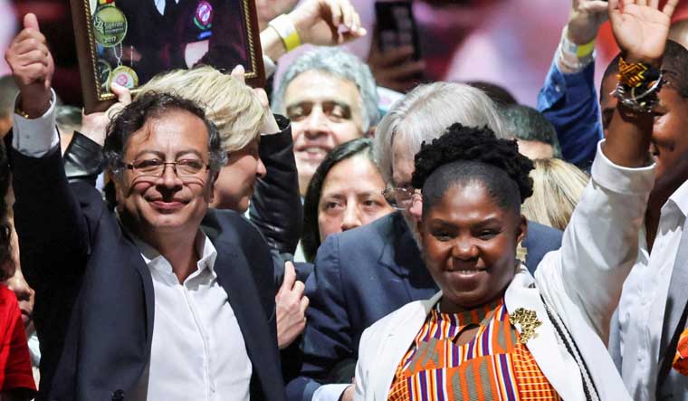 Colombian left-wing presidential candidate Gustavo Petro and his candidate for Vice-President Francia Marquez of the Historic Pact coalition celebrate after Petro's victory in the second round of the presidential election, at the Movistar Arena, in Bogota, Colombia June 19, 2022 | Reuters  