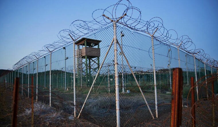 Chain link fence and concertina wire surrounds a deserted guard tower within Joint Task Force Guantanamo's Camp Delta at the U.S. Naval Base in Guantanamo Bay, Cuba March 21, 2016 | Reuters