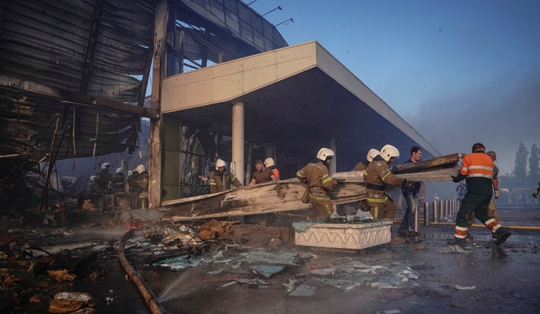 Rescuers work at a site of a shopping mall hit by a Russian missile strike, as Russia's attack on Ukraine continues, in Kremenchuk, in Poltava region, Ukraine June 27, 2022. Picture taken June 27, 2022. REUTERS/Anna Voitenko