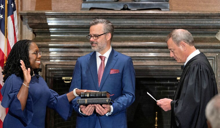 Judge Ketanji Brown Jackson takes her constitutional oath of office as an Associate Justice of the U.S. Supreme Court administered by Chief Justice John Roberts as Jackson’s husband Patrick Jackson holds the Bible in a handout image provided by the U.S. Supreme Court from ceremonies held at the Supreme Court building in Washington, U.S., June 30, 2022 | Reuters