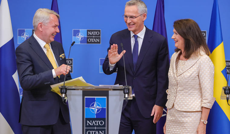 Finland's Foreign Minister Pekka Haavisto, left, Sweden's Foreign Minister Ann Linde, right, and NATO Secretary General Jens Stoltenberg attend a media conference after the signature of the NATO Accession Protocols  | AP