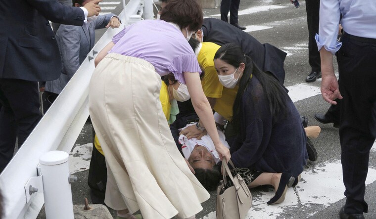 Former Japanese prime minister Shinzo Abe lies on the ground after apparent shooting during an election campaign for the July 10, 2022 Upper House election, in Nara, western Japan July 8, 2022. in this photo taken by Kyodo. Mandatory credit Kyodo via REUTERS ATTENTION EDITORS - THIS IMAGE WAS PROVIDED BY A THIRD PARTY. MANDATORY CREDIT. JAPAN OUT. NO COMMERCIAL OR EDITORIAL SALES IN JAPAN.