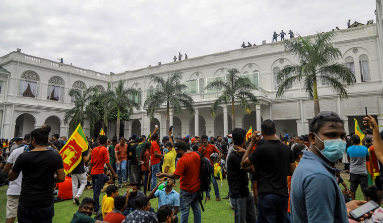 Protesters gather inside the premises of Sri Lankan presidents official residence in Colombo | AP