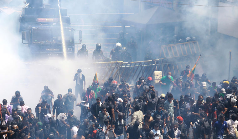 Police use water canon and tear gas to disperse the protesters in Colombo | AP