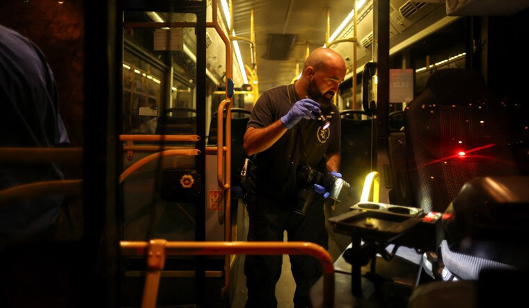 An Israeli police officer checks a bus following an incident in Jerusalem August 14, 2022. REUTERS/Ammar Awad