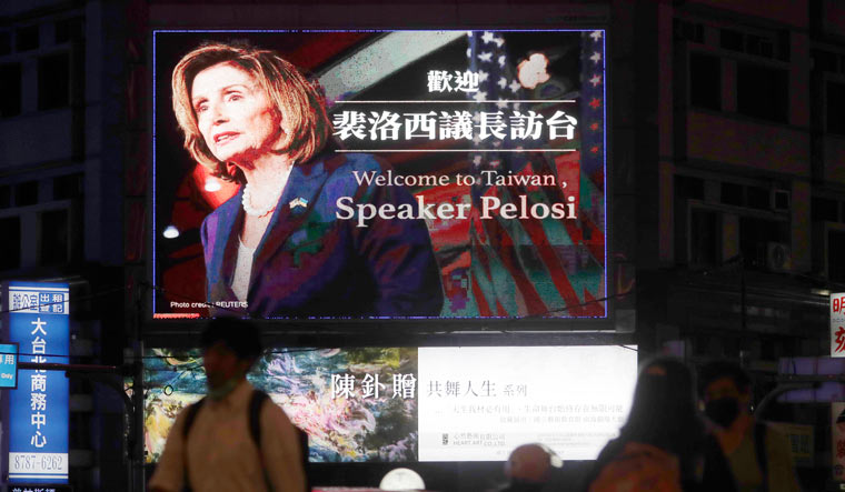 People walk past a billboard welcoming US House Speaker Nancy Pelosi, in Taipei, Taiwan | AP
