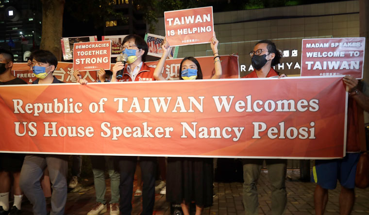 Supporters hold a banner outside the hotel where US House Speaker Nancy Pelosi is supposed to be staying in Taipei | AP
