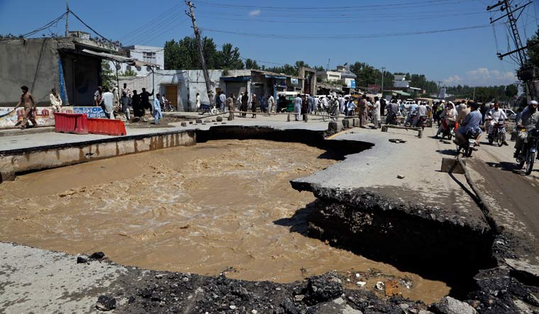 A road damaged from flooding on the outskirts of Peshawar, Pakistan | AP