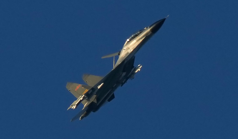 A Chinese J-11 military fighter jet flies above the Taiwan Strait near Pingtan | AP