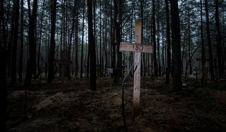 A view of unidentified graves of civilians and Ukrainian soldiers in a cemetery in the recently retaken area of Izium, Ukraine, Thursday, Sept. 15, 2022 who had been killed by Russian forces near the beginning of the war. A mass grave of Ukrainian soldiers and unknown buried civilians was found in the forest of recently recaptured city of Izium. (AP Photo/Evgeniy Maloletka)