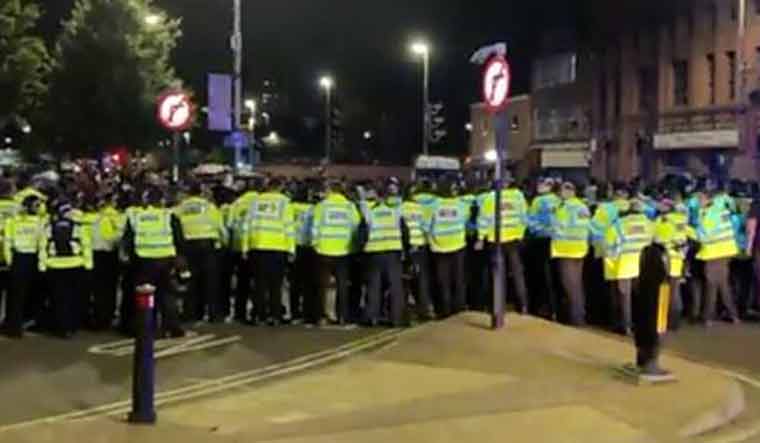 Police officers line up to keep order in UK's Leicester