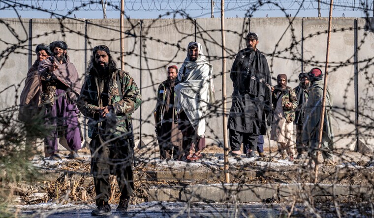 Taliban fighters check the site of an explosion, near the Interior Ministry, in Kabul, Afghanistan, Sunday, Jan. 1, 2023. A bomb exploded near a checkpoint at Kabul's military airport Sunday morning killing and wounding several people, a Taliban official said, the first deadly blast of 2023 in Afghanistan. (AP Photo/Ebrahim Noroozi)