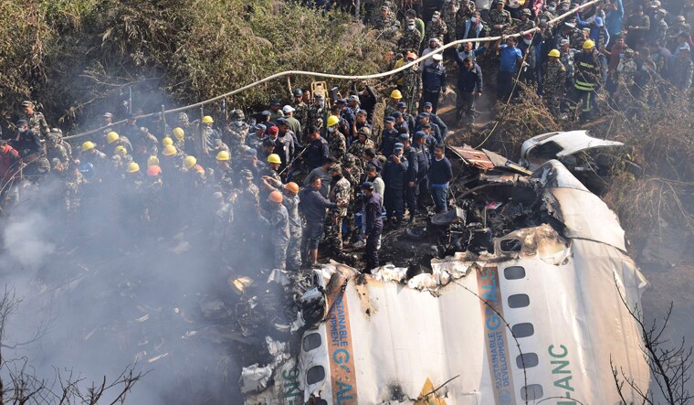 Nepalese rescue workers and civilians gather around the wreckage of a passenger plane that crashed in Pokhara, Nepal, Sunday, Jan. 15, 2023. Authorities in Nepal said 68 people have been confirmed dead after a regional passenger plane with 72 aboard crashed into a gorge while landing at a newly opened airport in the resort town of Pokhara. It's the country's deadliest airplane accident in three decades. (AP/PTI)(AP01_15_2023_000262A)