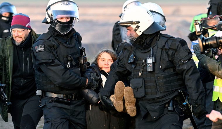 Police officers carry Swedish climate activist Greta Thunberg away from the edge of the Garzweiler II opencast lignite mine during a protest action by climate activists after the clearance of Luetzerath, Germany, Tuesday, Jan. 17, 2023. After the eviction of Luetzerath ended on Sunday, coal opponents continued their protests on Tuesday at several locations in North Rhine-Westphalia. (Federico Gambarini/dpa via AP)