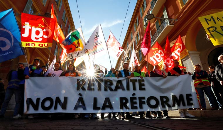 Protesters hold a banner and French labour unions flags during a demonstration against French government's pension reform plan in Nice as part of a day of national strike and protests in France, January 19, 2023 | Reuters
