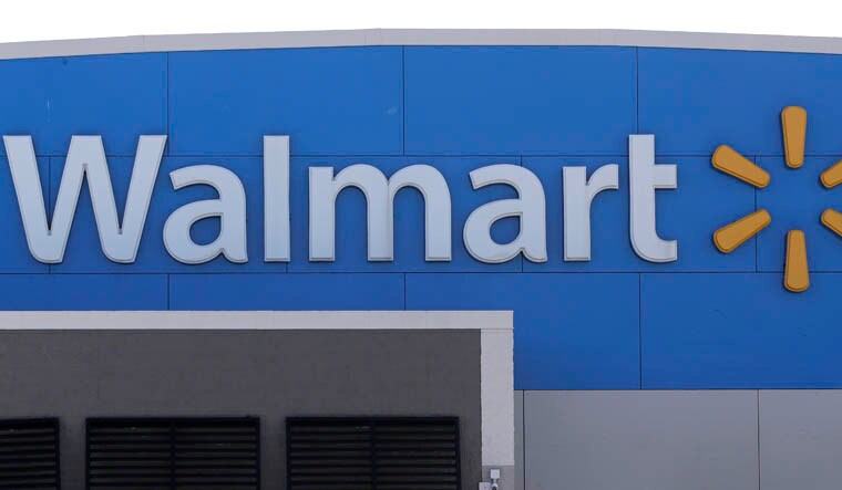 FILE - A Walmart logo is displayed outside of a Walmart store, in Walpole, Mass, Sept. 3, 2019. A man opened fire on police inside an Indiana Walmart before he was shot and killed by officers late Thursday, Jan. 19, 2023, authorities said. (AP Photo/Steven Senne, File)