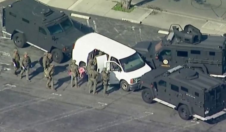 Police use armored vehicles to surround a white cargo van, believed by law enforcement to be connected to the Monterey Park mass shooting suspect according to an ABC affiliate, as a SWAT team conducts a search at a parking lot in Torrance, California, U.S. January 22, 2023 in a still image from video.  ABC Affiliate KABC via REUTERS NO RESALES. NO ARCHIVES. MANDATORY CREDIT