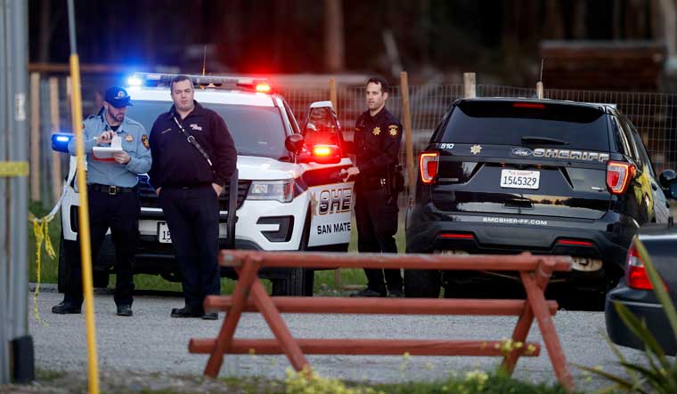 San Mateo County Sheriffs officers and EMS personnel gather along a road at a location near where multiple people were found shot to death on Monday in Half Moon Bay, California | AP 