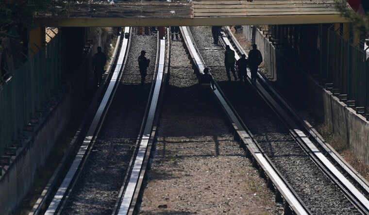 Rescue workers inspect rail lines after two subway trains collided, in Mexico City, Saturday, Jan. 7, 2023. Authorities announced at least one person was killed and dozens were injured in the Saturday accident on Line 3 of the capital's subway. (AP Photo/Fernando Llano)
