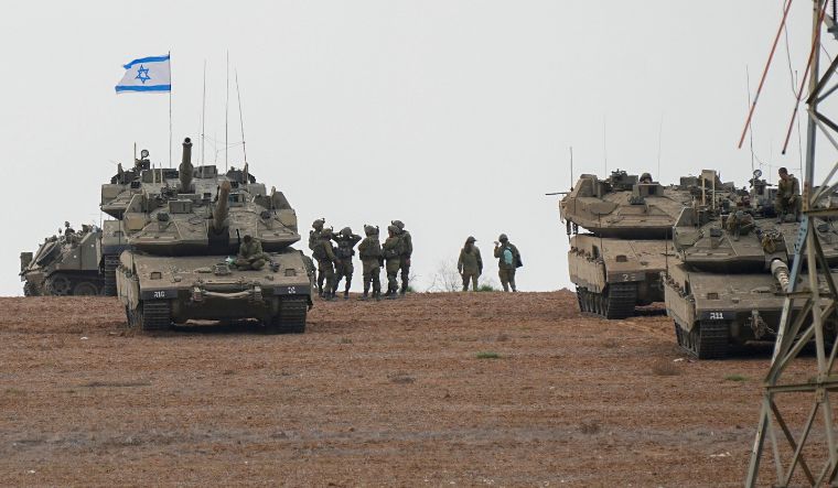 Israeli soldiers are seen in a staging ground near the Gaza border, southern Israel on October 9, 2023 | AP