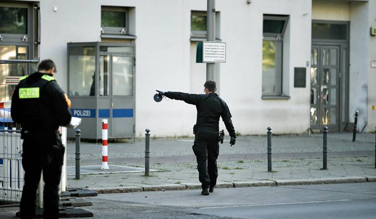 Police officers look for traces in front of the building complex of the Kahal Adass Jisroel community, which houses a synagogue, a kindergarten and a community center, in the center of Berlin, Germany, Wednesday, Oct. 18, 2023 | AP