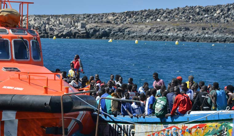 Migrants wait to disembark from a small boat in La Restinga on the Canary Island of El Hierro, Spain, Saturday Oct. 21, 2023 | AP
