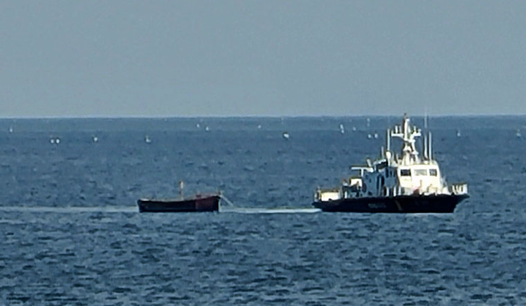 A small wooden boat is towed into a port in Yangyang, South Korea, Tuesday, Oct. 24, 2023 | AP