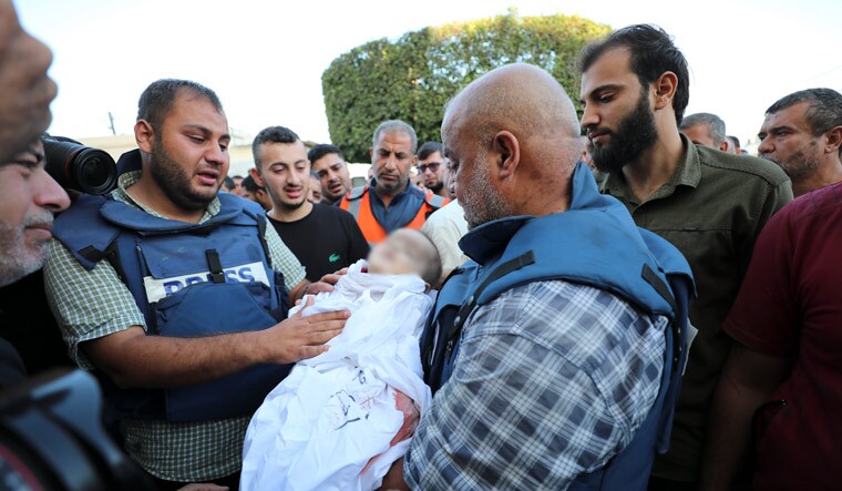 Al-Jazeera correspondent Wael Dahdouh holds his grandson killed in an Israeli airstrike at Nuisserat refugee camp, outside a hospital in Deir al Balah, south of the Gaza Strip, Thursday, Oct. 26, 2023 | AP