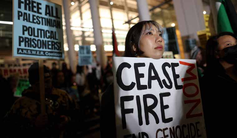  A pro-Palestinian activist holds a sign during a protest in San Francisco | AFP 