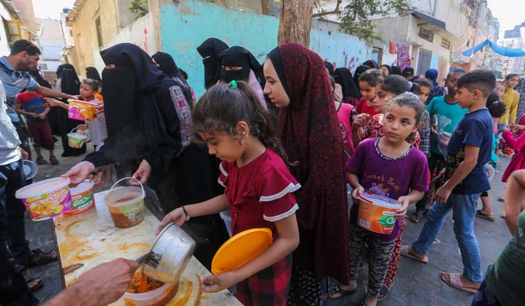 Palestinians receive food in Rafah, southern Gaza Strip | AP