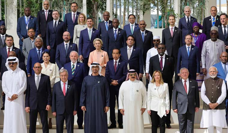 Participating world leaders and delegates pose for a photo during the COP28 United Nations climate summit in Dubai | AFP