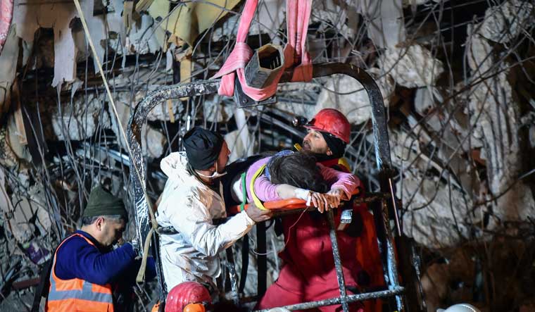 Rescuers pull out a woman from a collapsed building 87 hours after the earthquake in Kahramanmaras, southern Turkey, Thursday | Reuters
