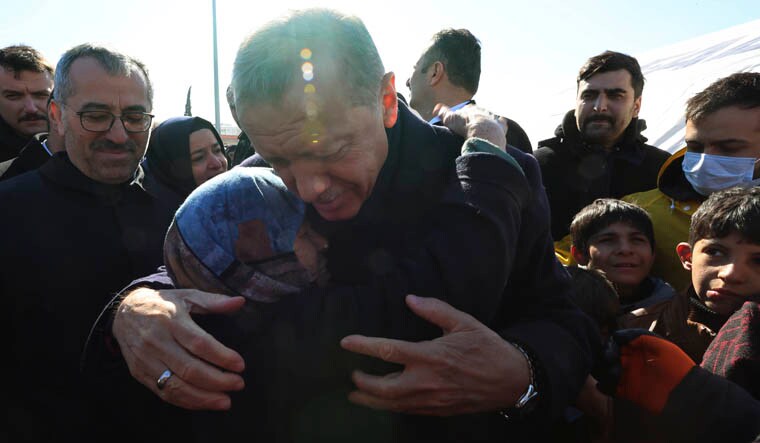 Turkey's President Recep Tayyip Erdogan and a survivor hug each other as he visits the city center destroyed by Monday earthquake in Kahramanmaras, southern Turkey, Wednesday, Feb. 8, 2023. Thinly stretched rescue teams worked through the night in Turkey and Syria, pulling more bodies from the rubble of thousands of buildings toppled by a catastrophic earthquake. The death toll rose Wednesday, making the quake the deadliest in more than a decade. (Turkish Presidency via AP )