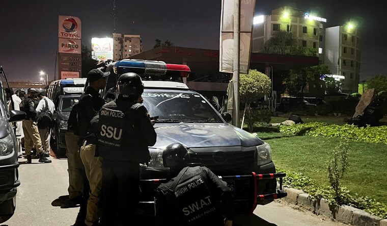 Police officers take position after a police office building was attacked by gunmen in Karachi, Pakistan February 17, 2023. REUTERS/Akhtar Soomro